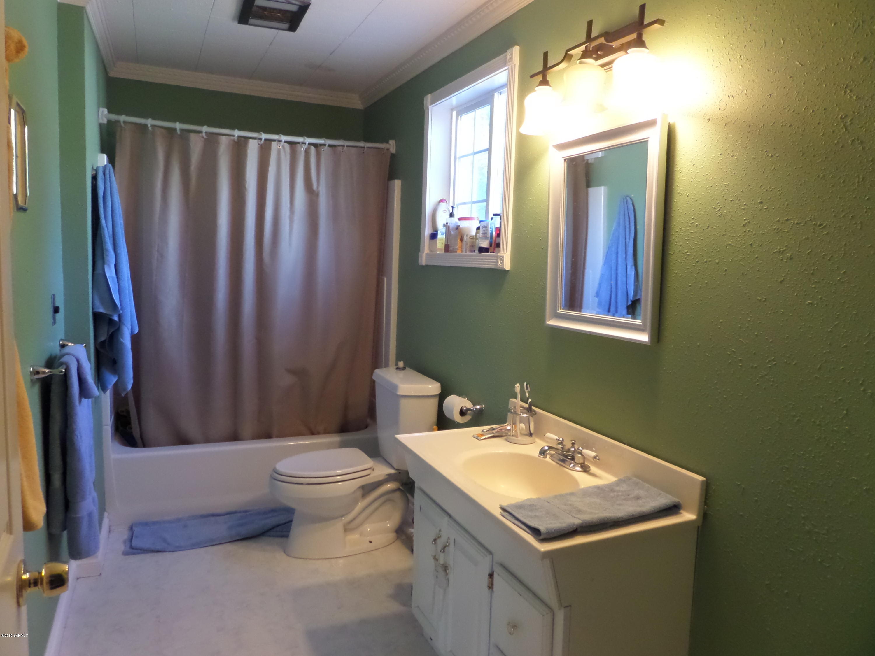 1551 Lombard Loop Road Wapato, WA 98951 - Photo 13 of 16 a bathroom with a granite countertop sink toilet and mirror