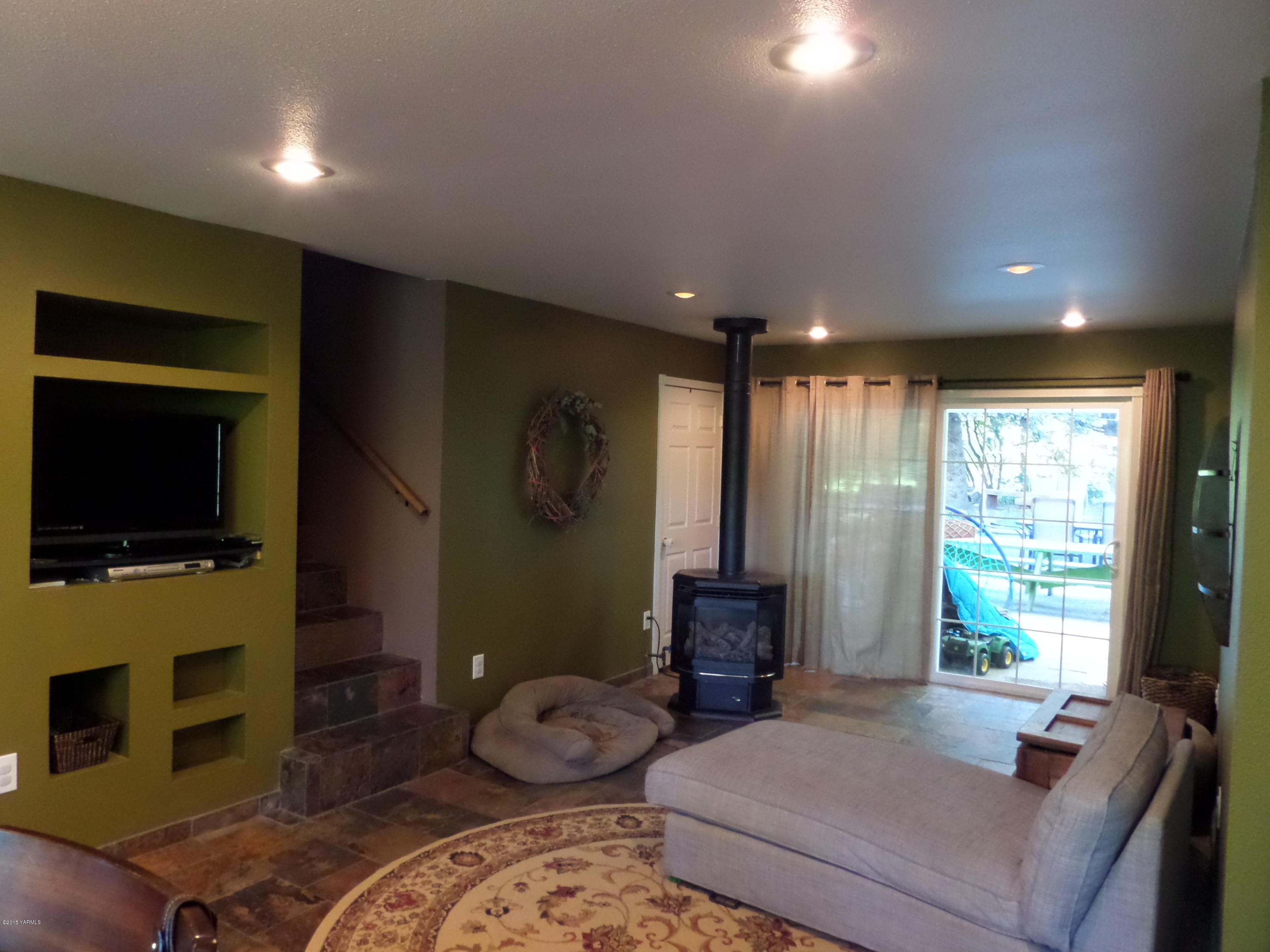 1551 Lombard Loop Road Wapato, WA 98951 - Photo 15 of 16 a bedroom with furniture and a flat screen tv