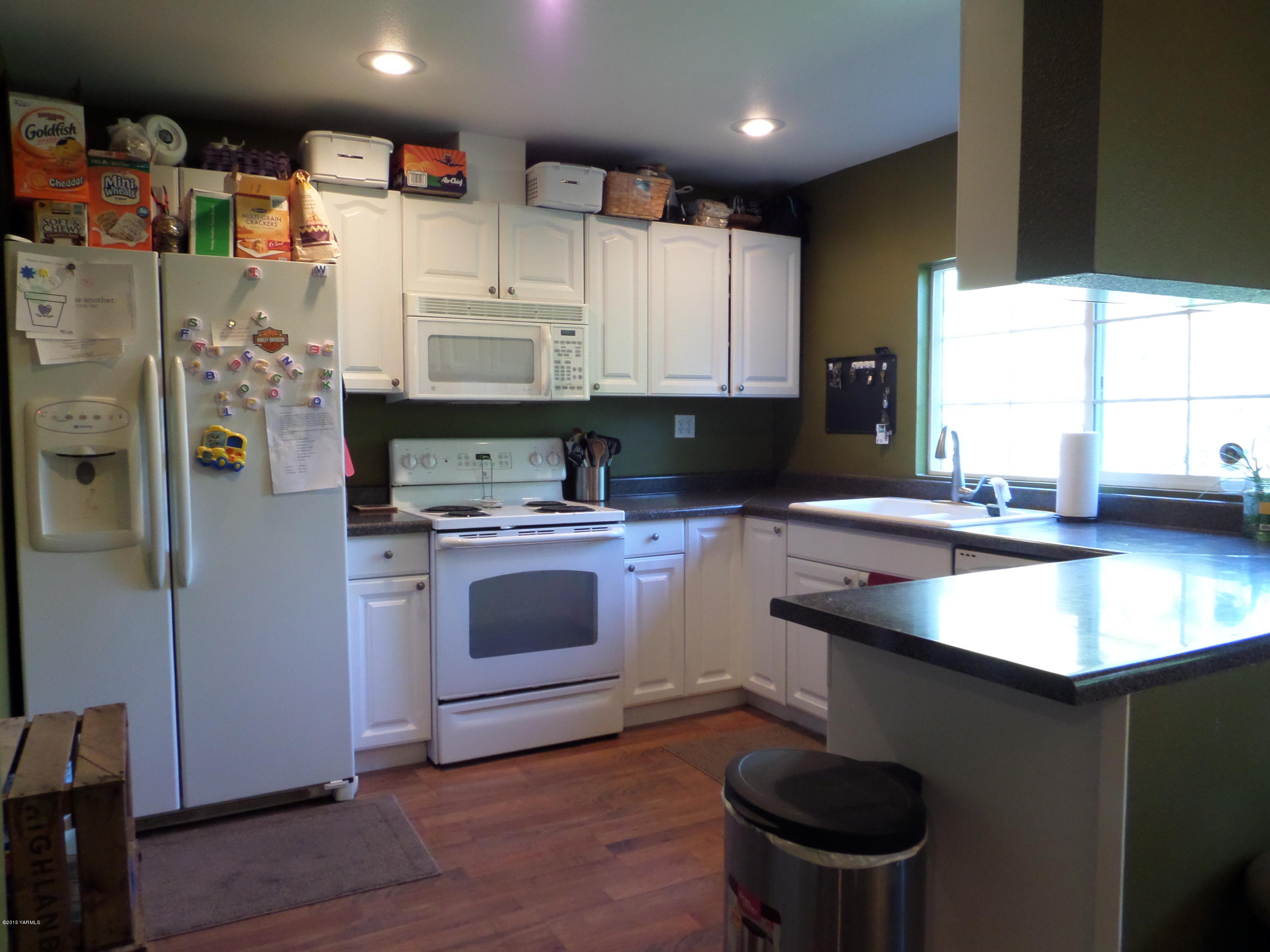 1551 Lombard Loop Road Wapato, WA 98951 - Photo 4 of 16 a kitchen with stainless steel appliances granite countertop a sink stove and refrigerator