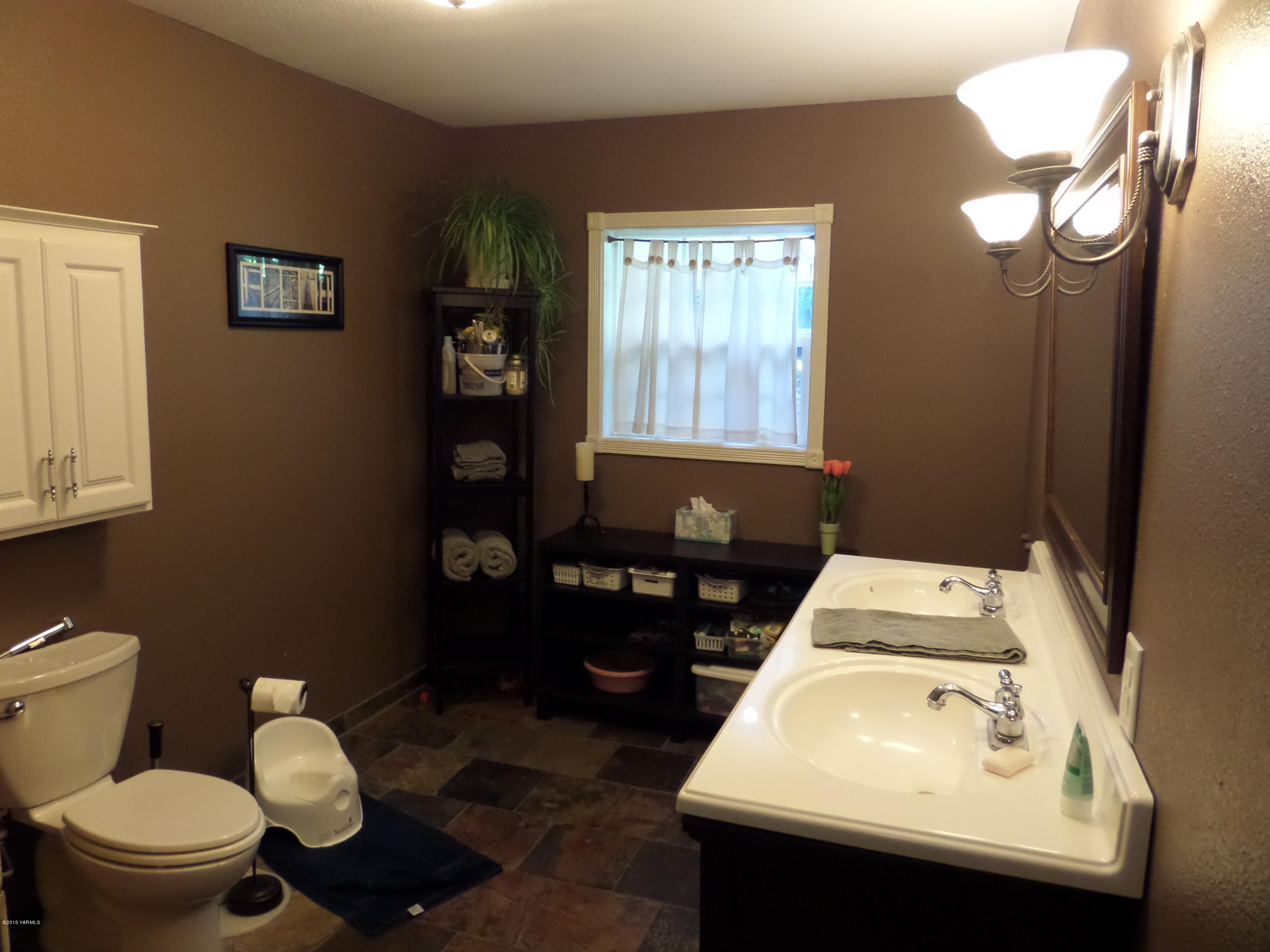 1551 Lombard Loop Road Wapato, WA 98951 - Photo 6 of 16 a bathroom with a sink toilet and a mirror