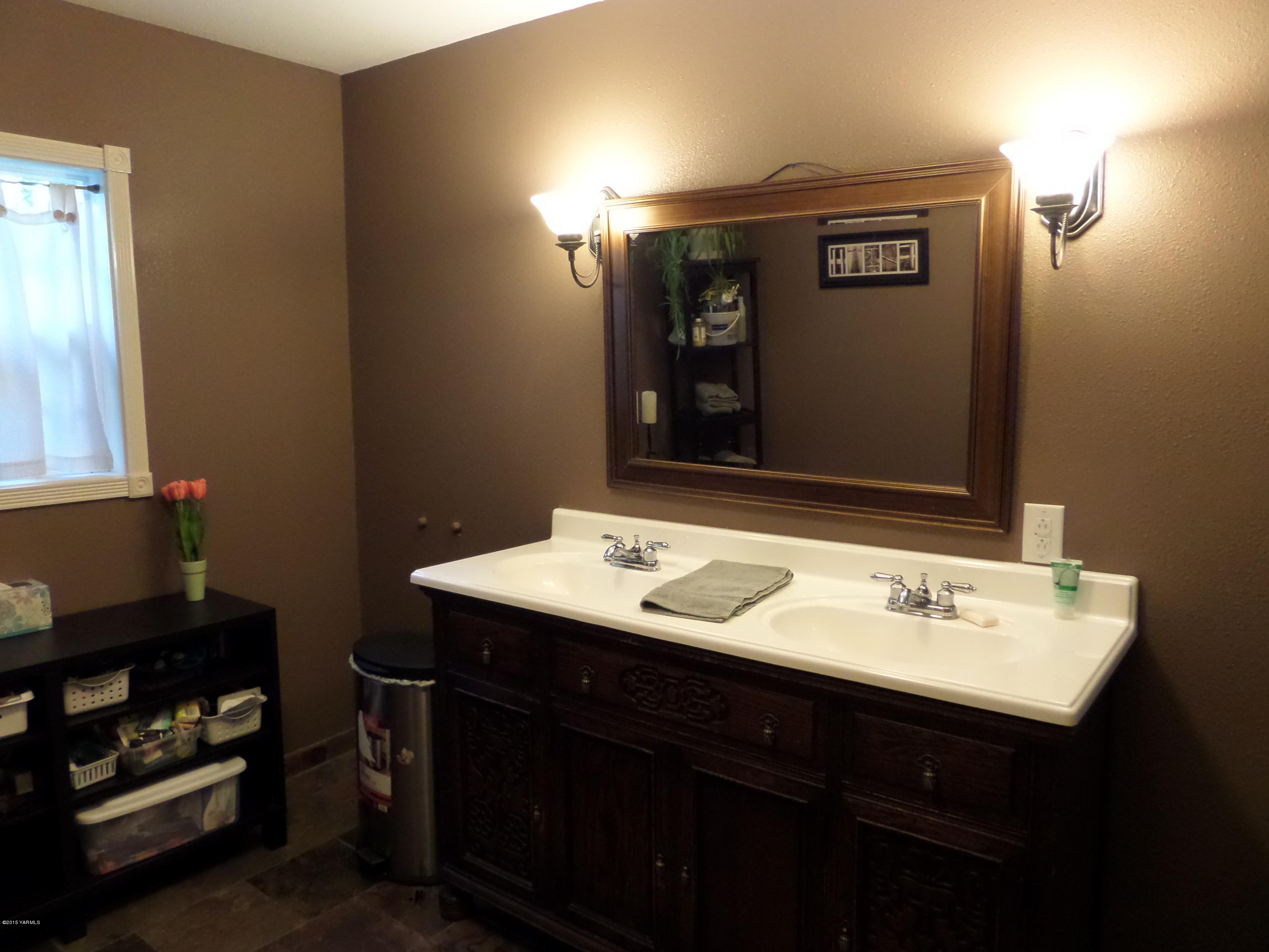 1551 Lombard Loop Road Wapato, WA 98951 - Photo 7 of 16 a bathroom with a sink and a mirror
