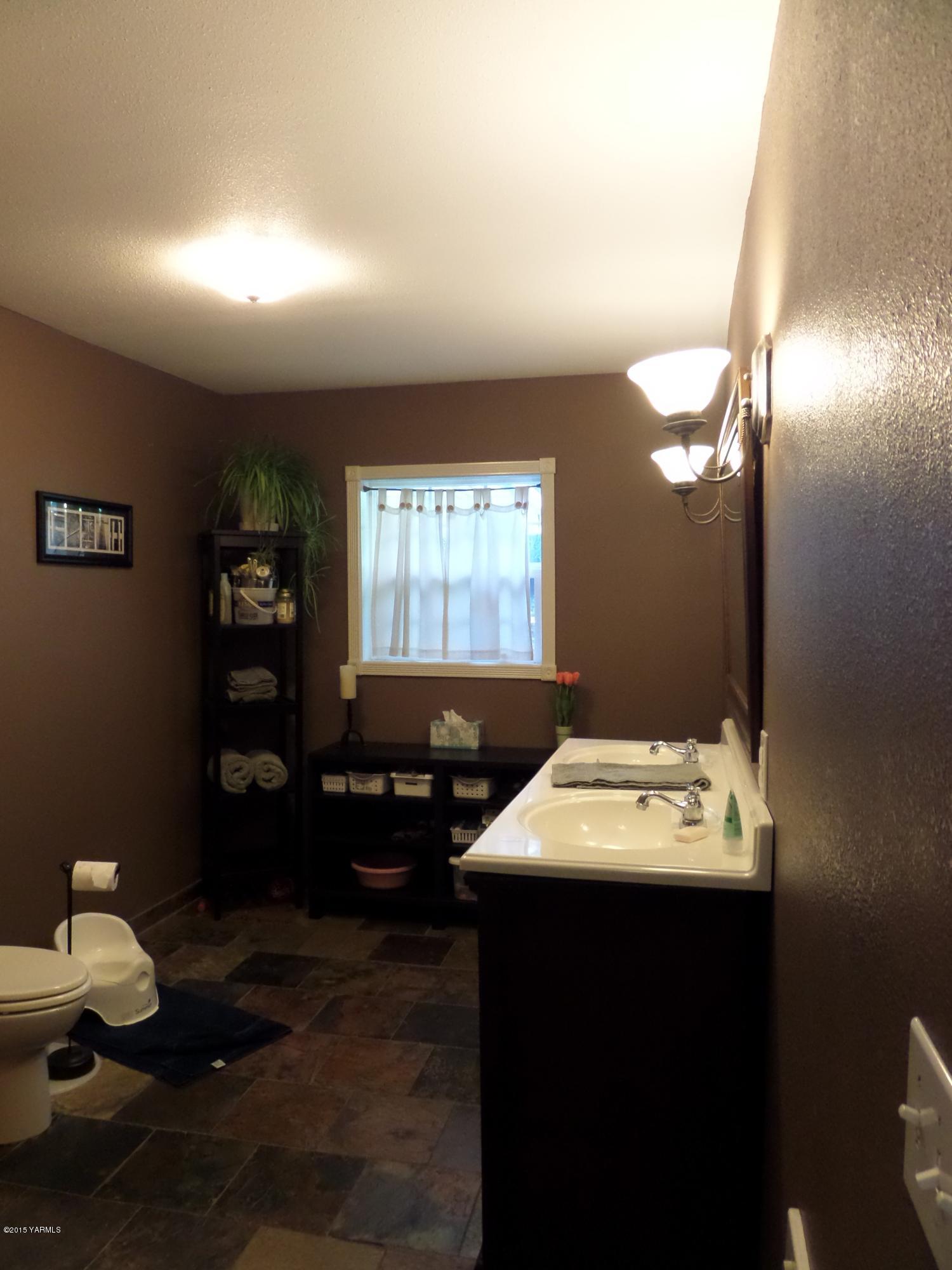 1551 Lombard Loop Road Wapato, WA 98951 - Photo 8 of 16 a bathroom with a sink vanity and a mirror