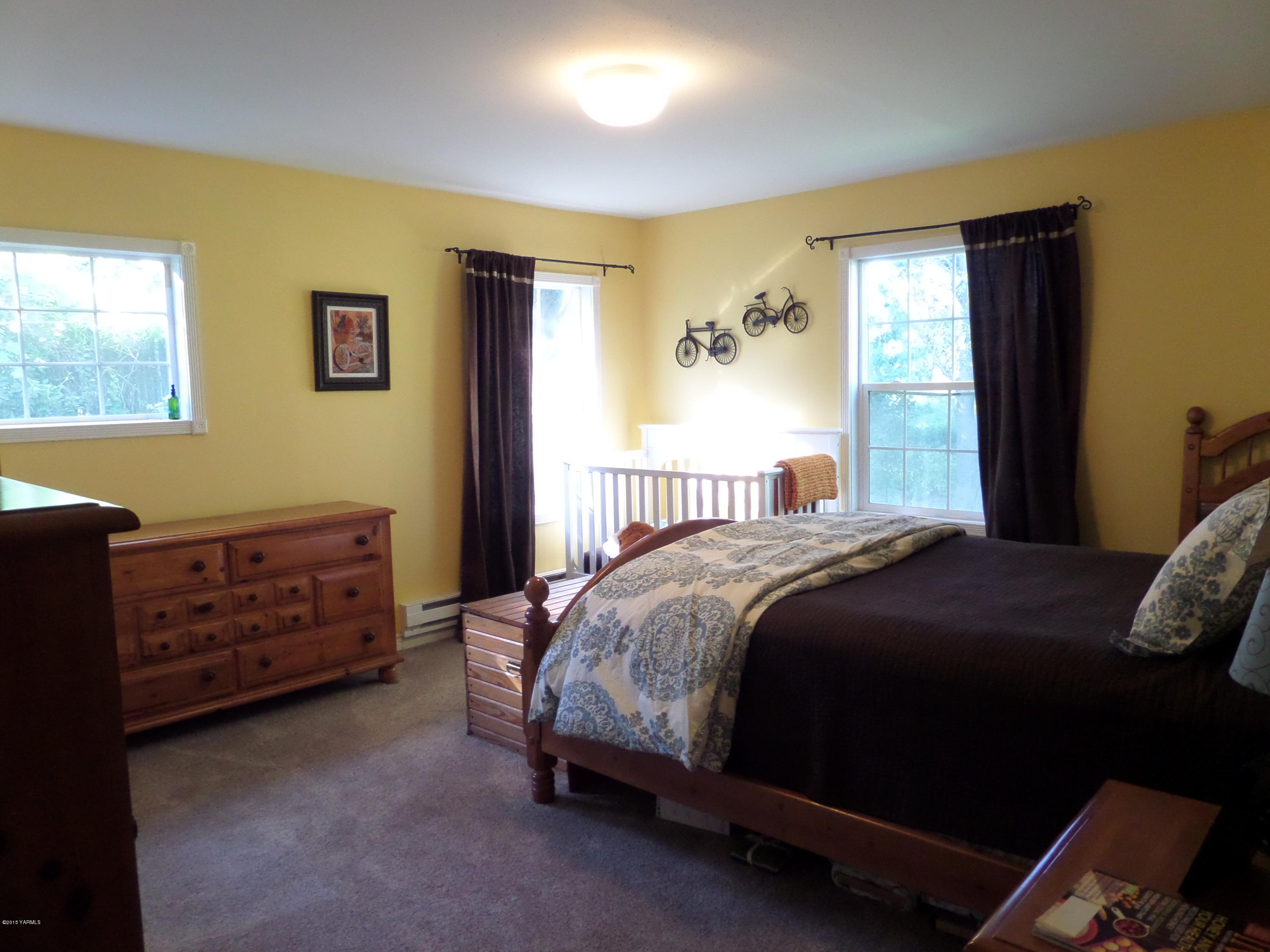1551 Lombard Loop Road Wapato, WA 98951 - Photo 9 of 16 a bedroom with a bed and a window