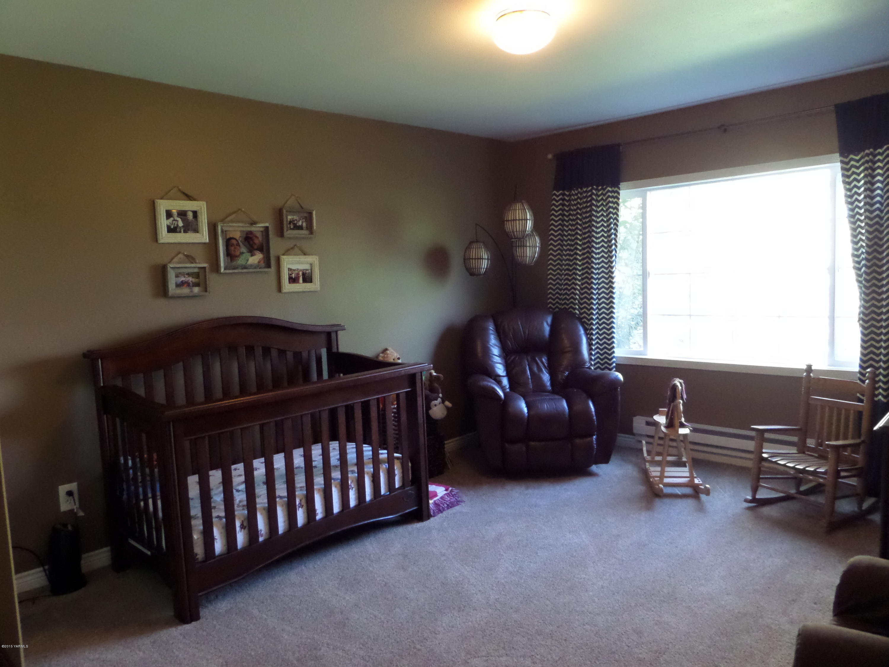 1551 Lombard Loop Road Wapato, WA 98951 - Photo 10 of 16 a bedroom with a bed and a couch