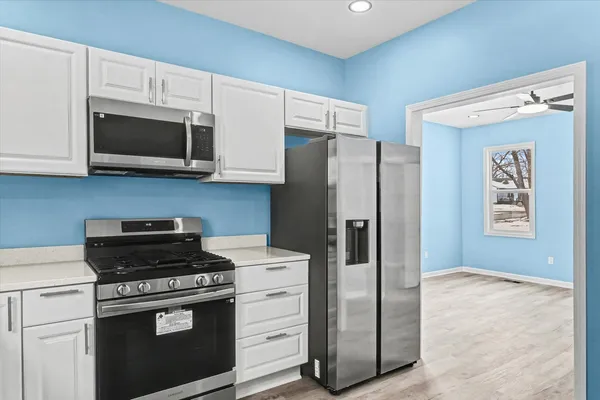 a kitchen with a refrigerator stove and microwave