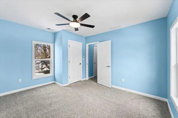 a view of a livingroom with a ceiling fan and window