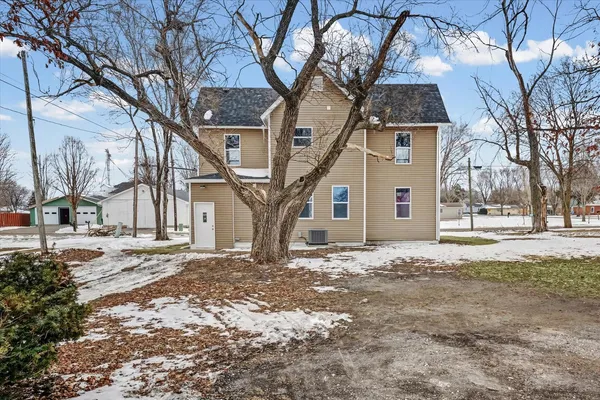 a view of a yard with snow on the tree