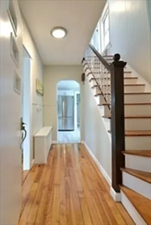 a view of a hallway view with wooden floor and staircase