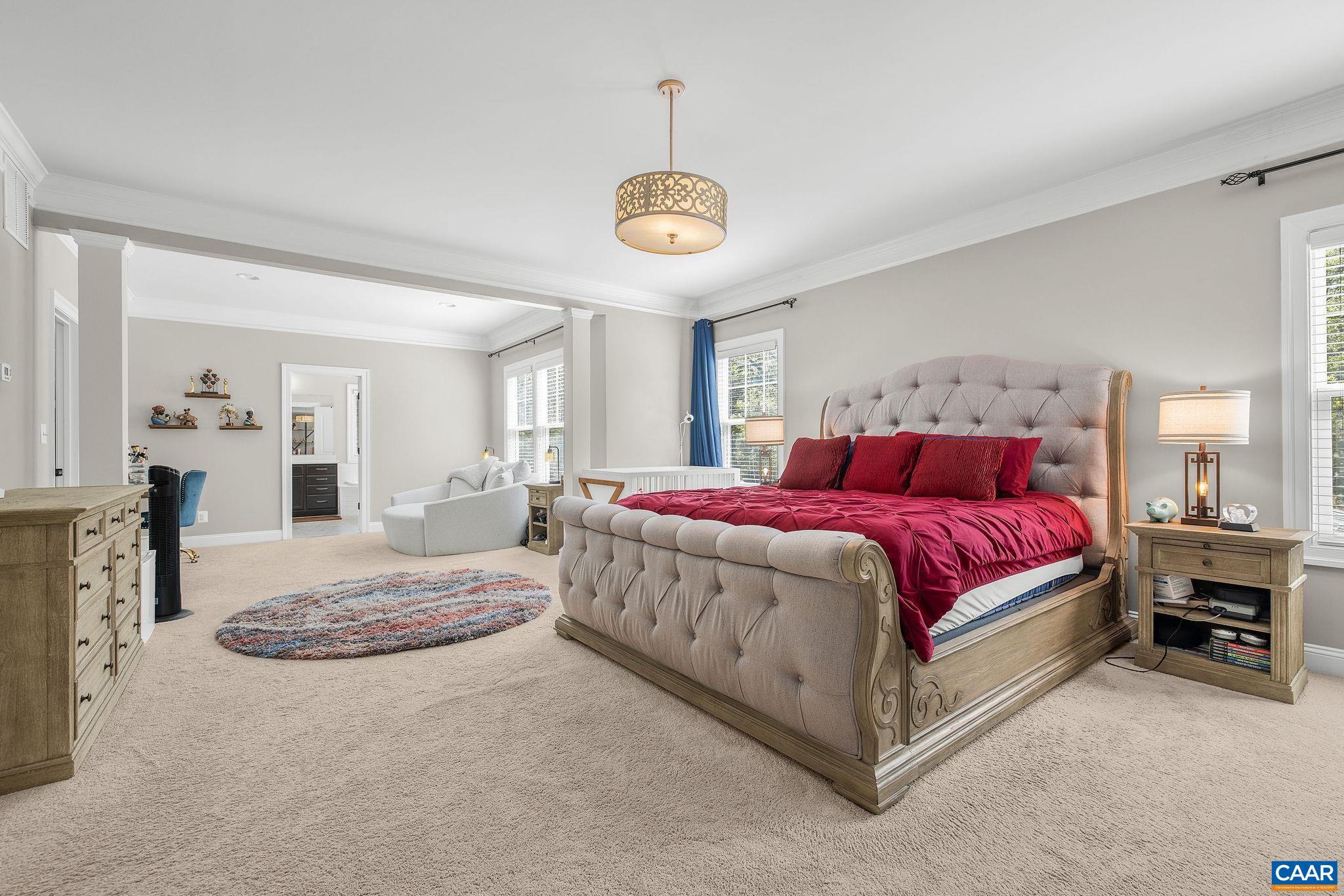 1630 Victor Place Charlottesville, VA 22903 - Photo 35 of 73 a spacious bedroom with a bed and a chandelier