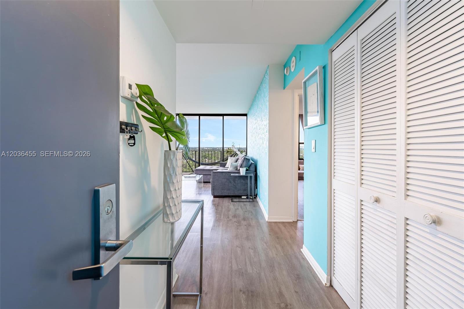 780 Northeast 69th Street, Unit 1010 Miami, FL 33138 - Photo 6 of 31 a view of a hallway with wooden floor and staircase