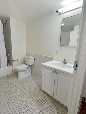 a bathroom with a sink toilet and mirror