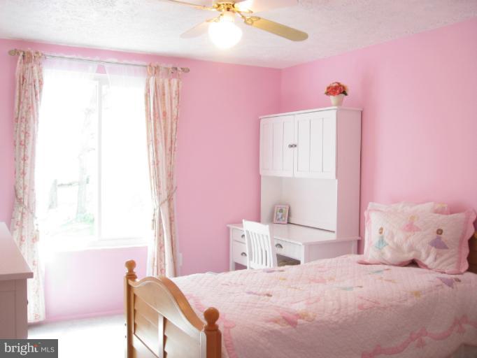 1121 Riva Ridge Drive Great Falls, VA 22066 - Photo 14 of 21 a bedroom with a bed dresser and a window