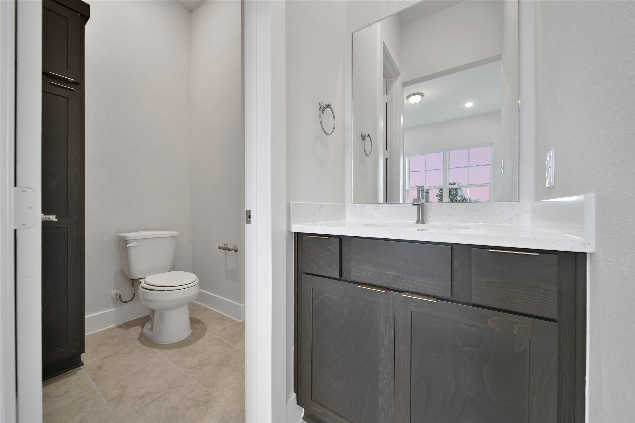 4602 Magnolia Bend Drive Rosharon, TX 77583 - Photo 25 of 39 a bathroom with a granite countertop sink a toilet and a mirror