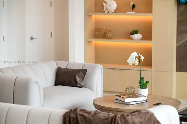 a living room with furniture and large windows