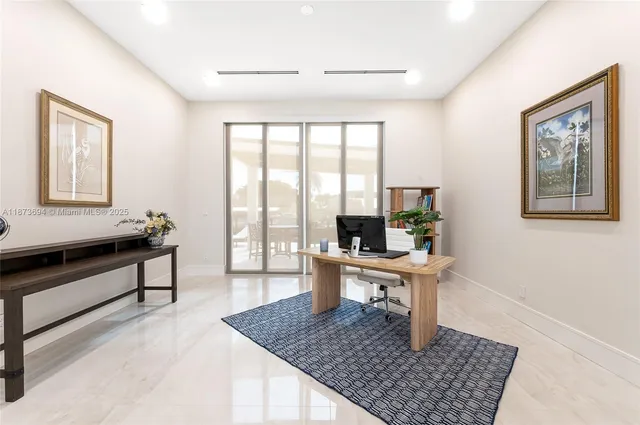 a living room with furniture and large windows