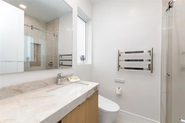 a spacious bedroom with a bed and a cabinets