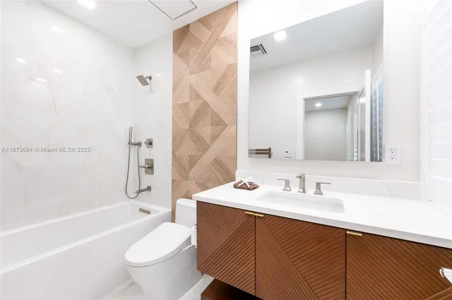 a bathroom with a sink a toilet and a bathtub