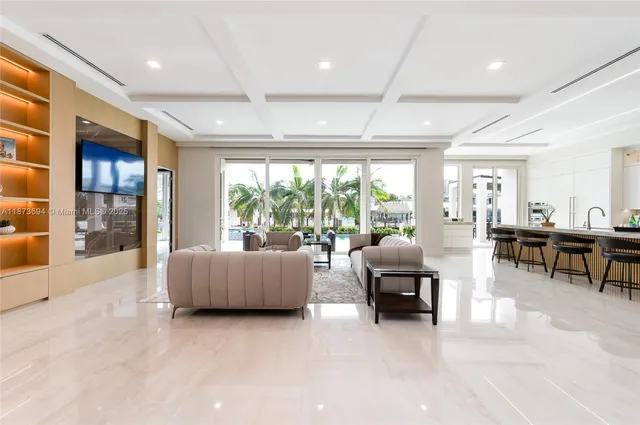a living room with furniture and large windows