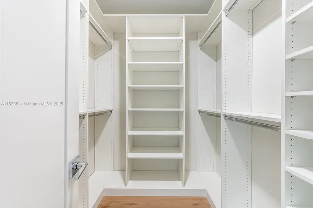 a view of a backyard with plants and lake view