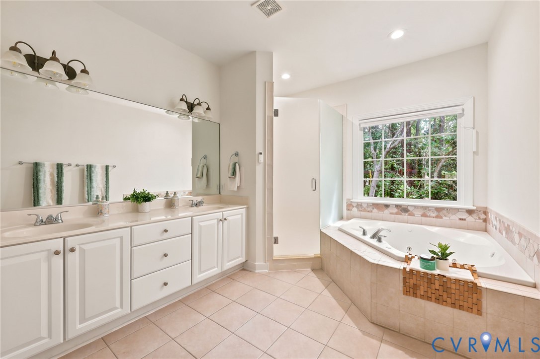4701 Regal Oaks Road Glen Allen, VA 23059 - Photo 25 of 60 a spacious bathroom with a tub sink and mirror