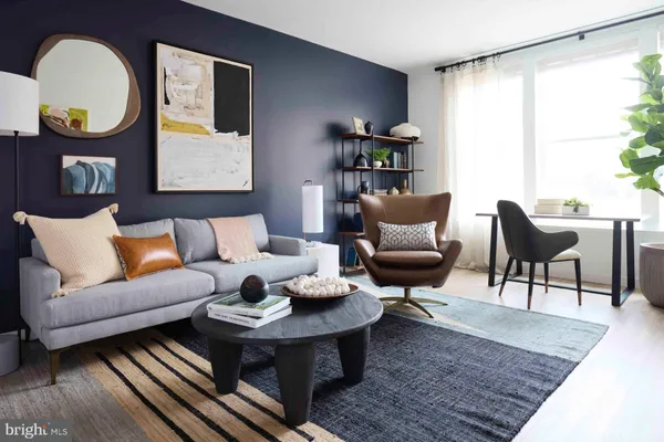 a living room with furniture a rug and a large window