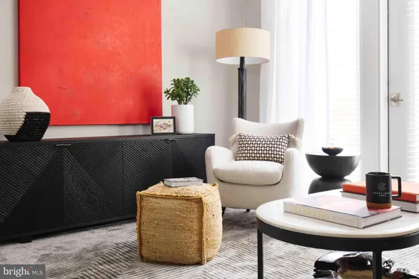 a living room with furniture and a lamp