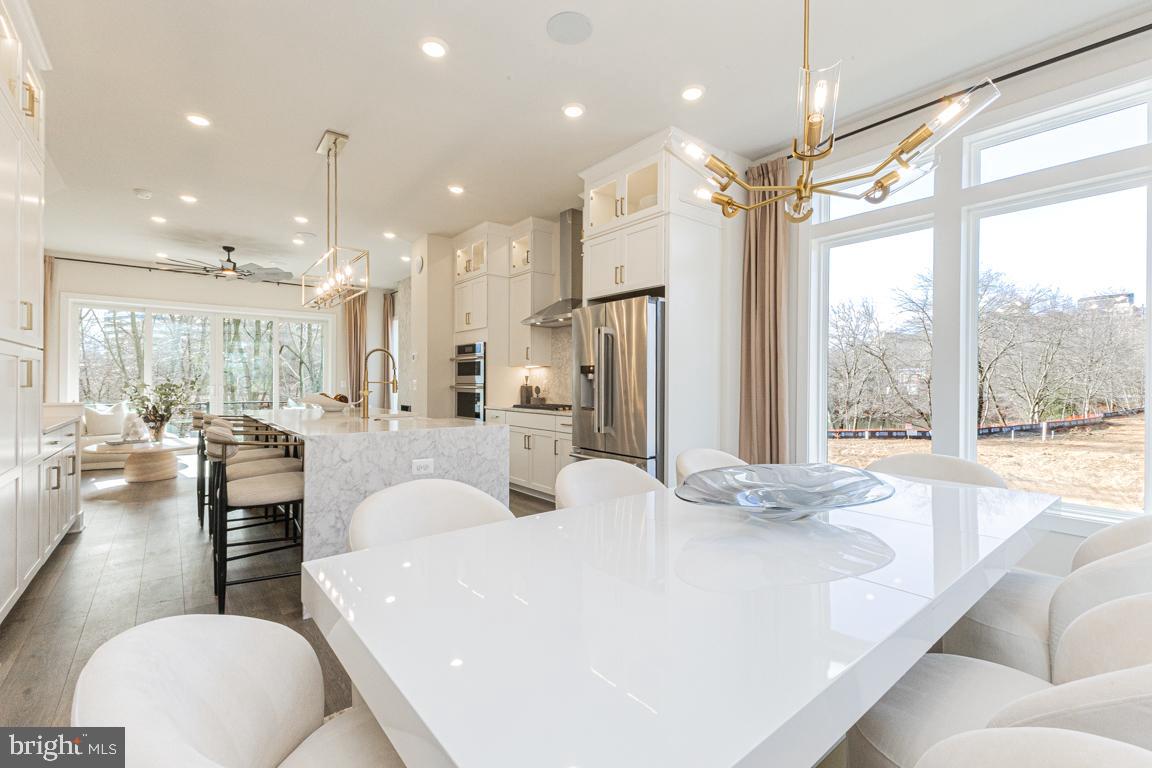 11652 American Dream Way Reston, VA 20190 - Photo 16 of 51 a large white kitchen with a large window and stainless steel appliances