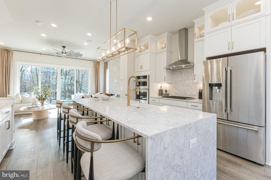 11652 American Dream Way Reston, VA 20190 - Photo 17 of 51 a kitchen with kitchen island a large counter top space appliances and cabinets