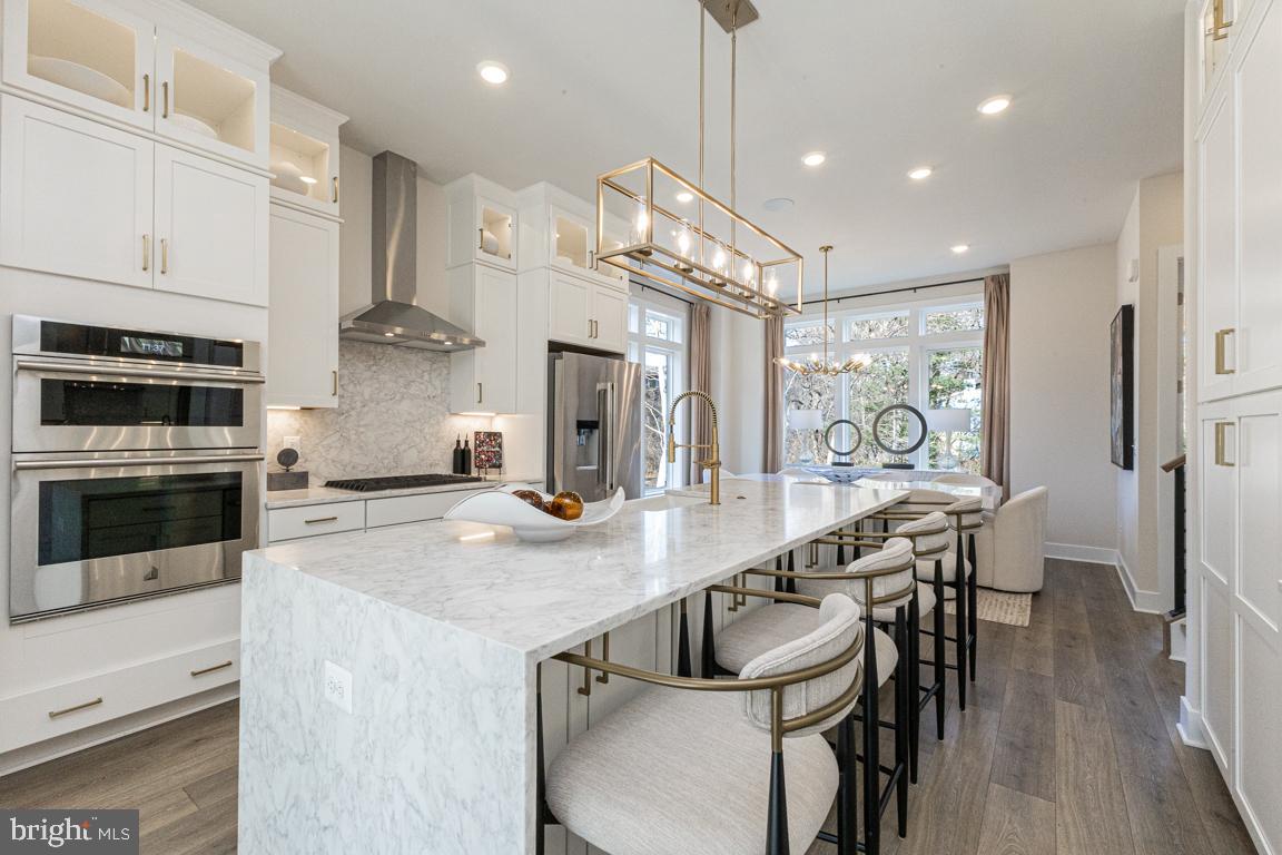 11652 American Dream Way Reston, VA 20190 - Photo 19 of 51 a kitchen with stainless steel appliances kitchen island a large island in the center and cabinets