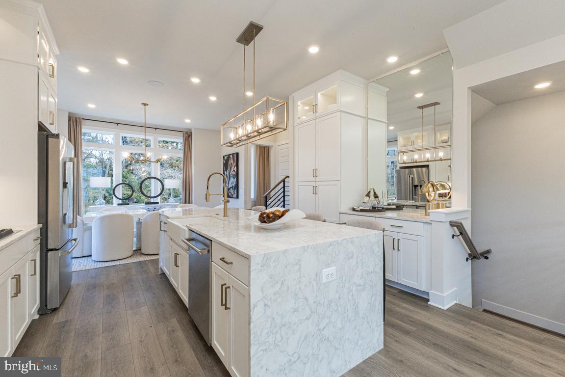 11652 American Dream Way Reston, VA 20190 - Photo 20 of 51 a kitchen with counter top space a sink stainless steel appliances and cabinets
