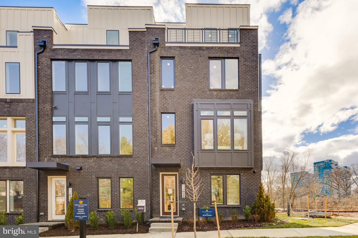 11652 American Dream Way Reston, VA 20190 - Photo 2 of 51 a front view of a residential apartment building with a yard