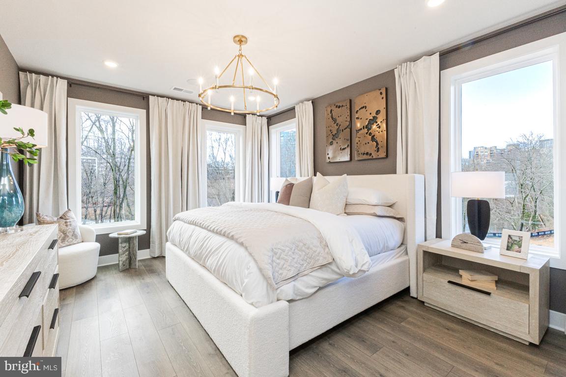 11652 American Dream Way Reston, VA 20190 - Photo 21 of 51 a bedroom with a large bed and a chandelier