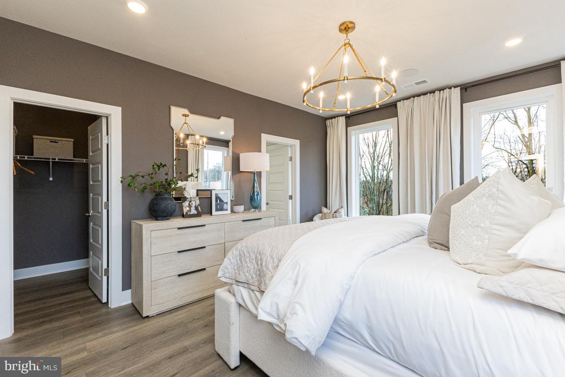 11652 American Dream Way Reston, VA 20190 - Photo 23 of 51 a bedroom with a large bed and a chandelier
