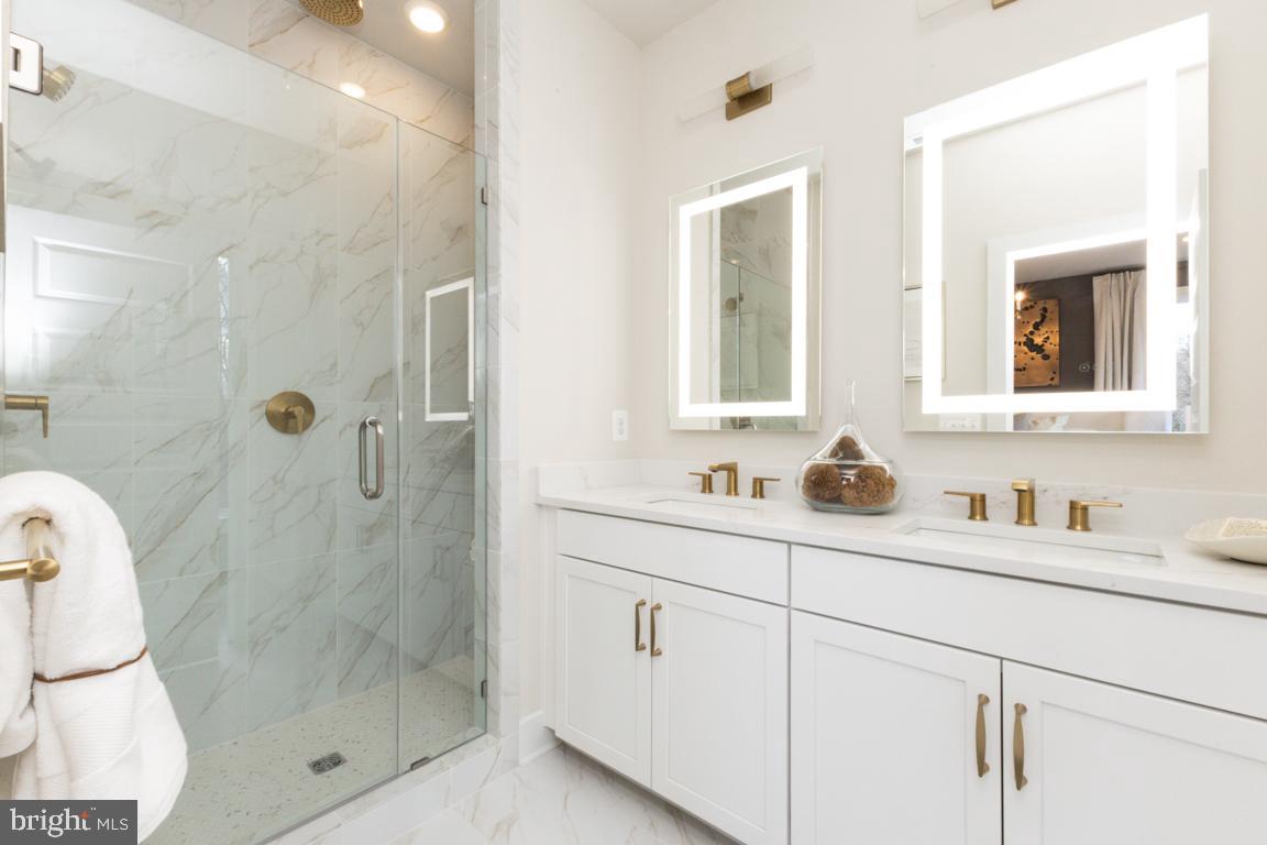 11652 American Dream Way Reston, VA 20190 - Photo 24 of 51 a bathroom with a shower sink and mirror