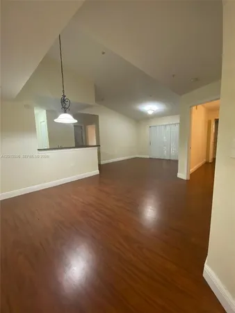 a view of a room with wooden floor and windows