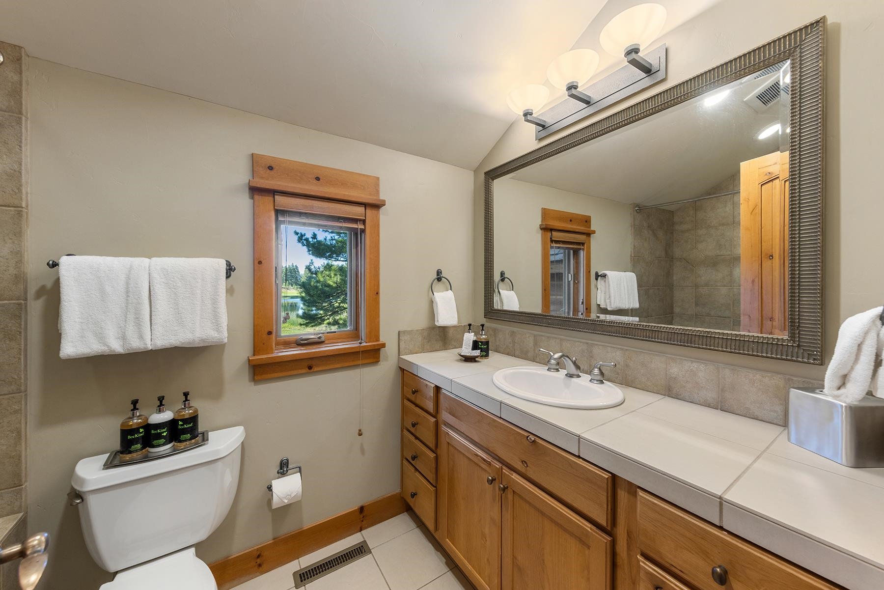 12202 Lookout Loop, Unit F2030 Truckee, CA 96161 - Photo 17 of 28 a bathroom with a granite countertop sink mirror vanity and toilet