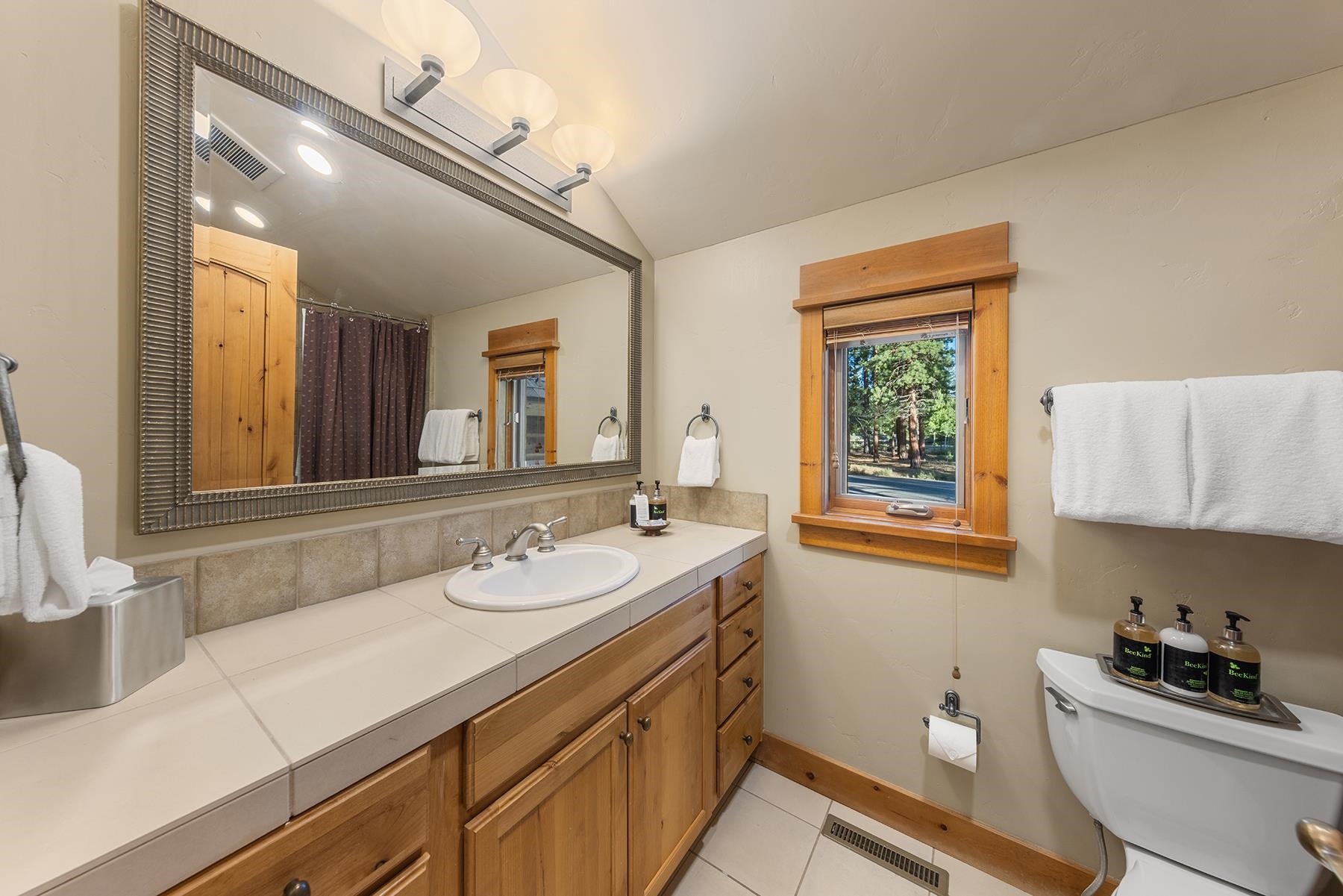 12202 Lookout Loop, Unit F2030 Truckee, CA 96161 - Photo 19 of 28 a bathroom with a sink and a mirror