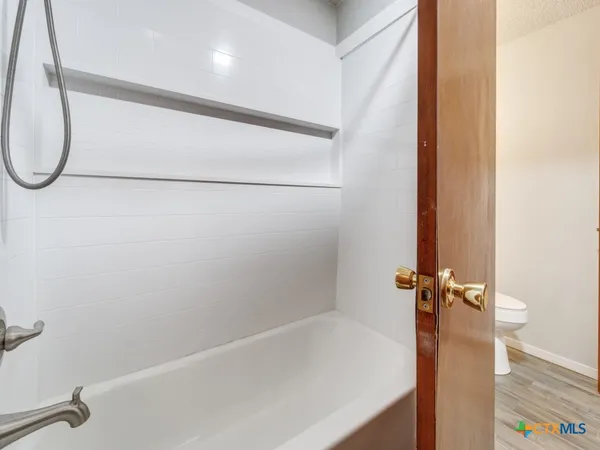 a bathroom with a shower and a bathtub