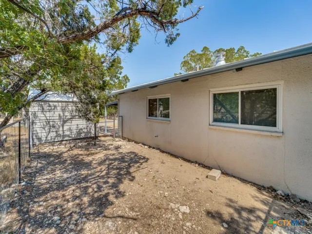 a backyard of a house with a tree