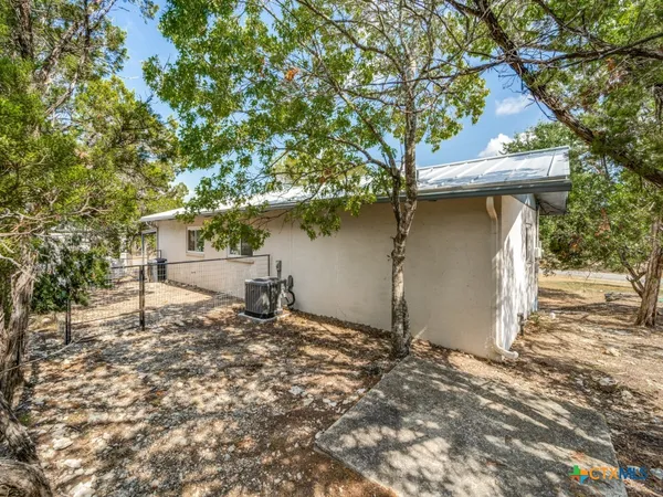 a backyard of a house with a tree