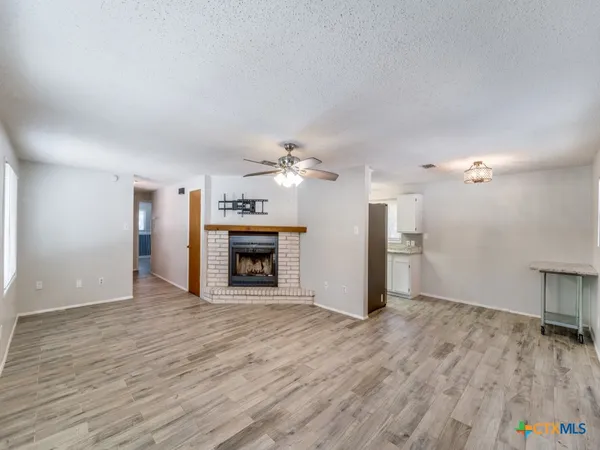 a view of a room wooden floor and a fireplace