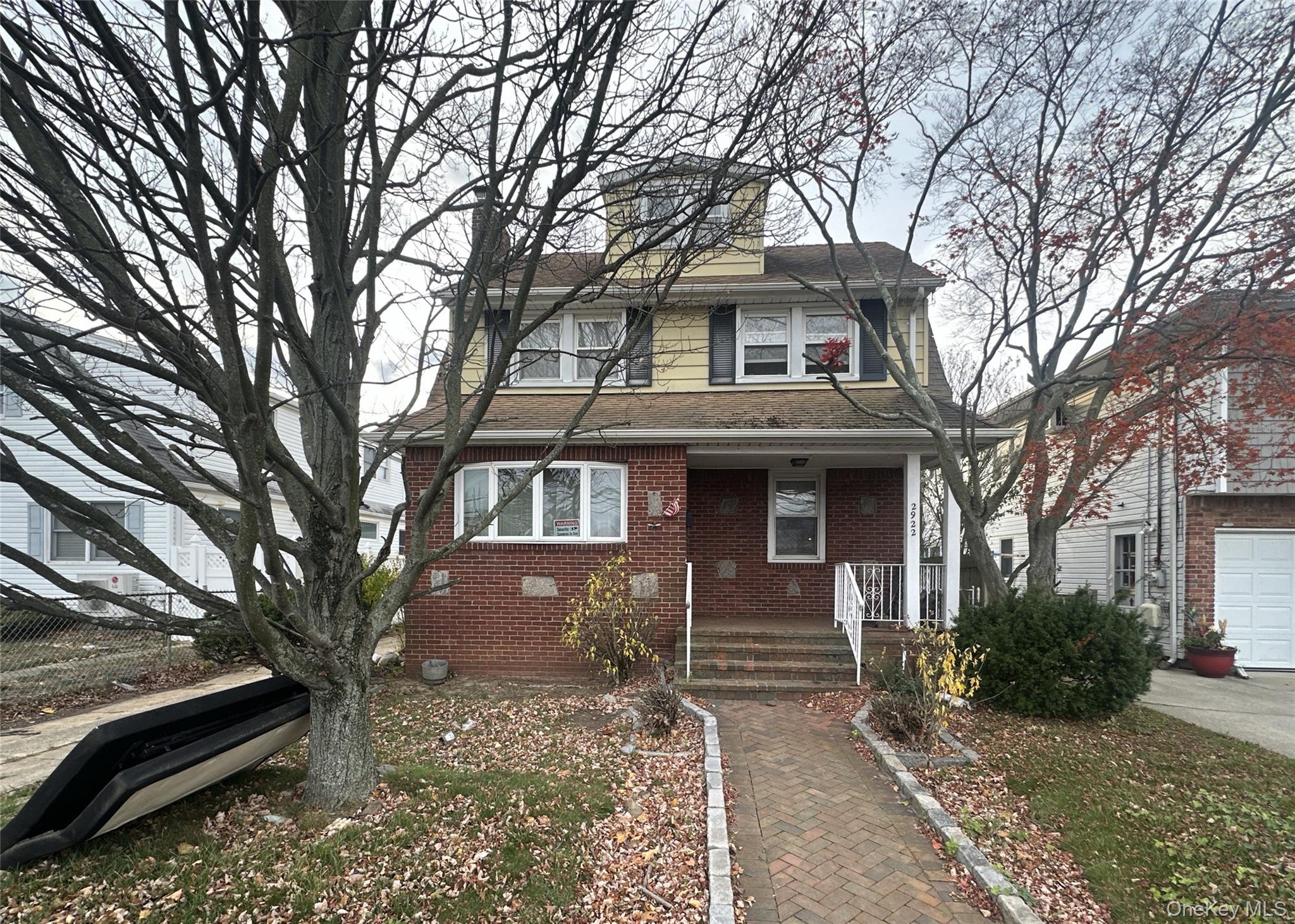 2922 Oceanside Road Oceanside, NY 11572 - Photo 1 of 1 a front view of a house with a yard
