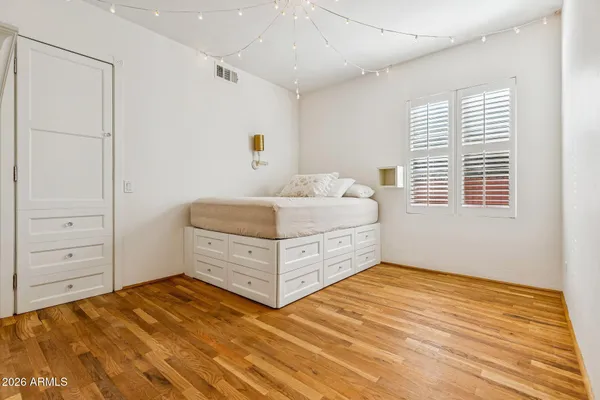 a bedroom with a bed and a window