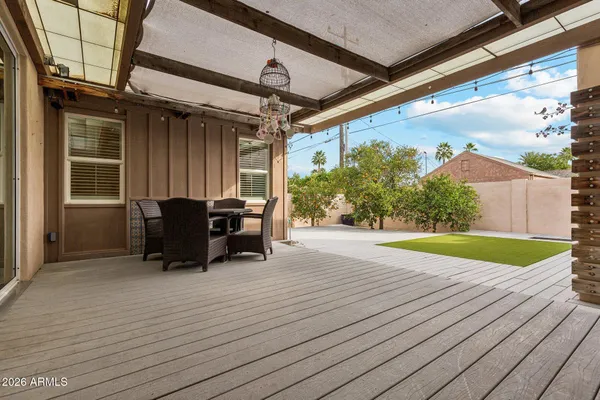 a view of a patio with table and chairs