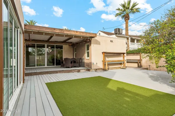 a view of a house with backyard and a patio