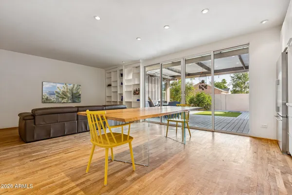 a dining room with furniture and wooden floor