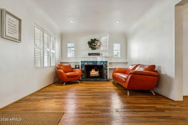 a living room with furniture floor to ceiling window and fireplace