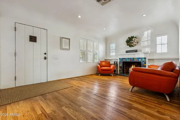 a living room with furniture a fireplace and a flat screen tv
