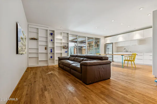 a living room with furniture and a wooden floor