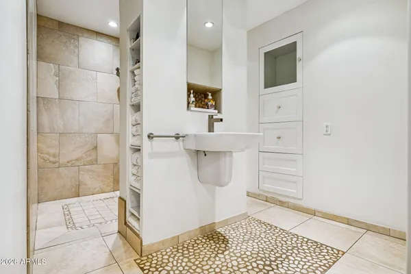 a bathroom with a sink a toilet and shower